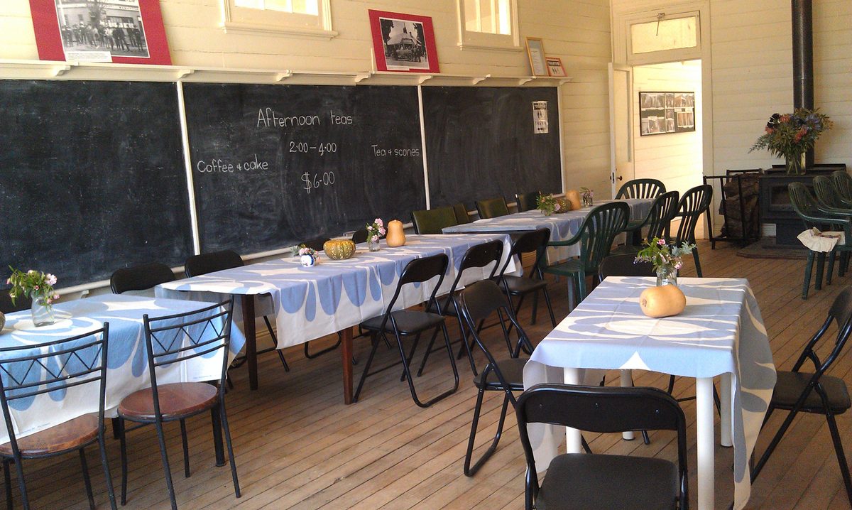 The main classroom set out for afternoon teas, with the original blackboards behind