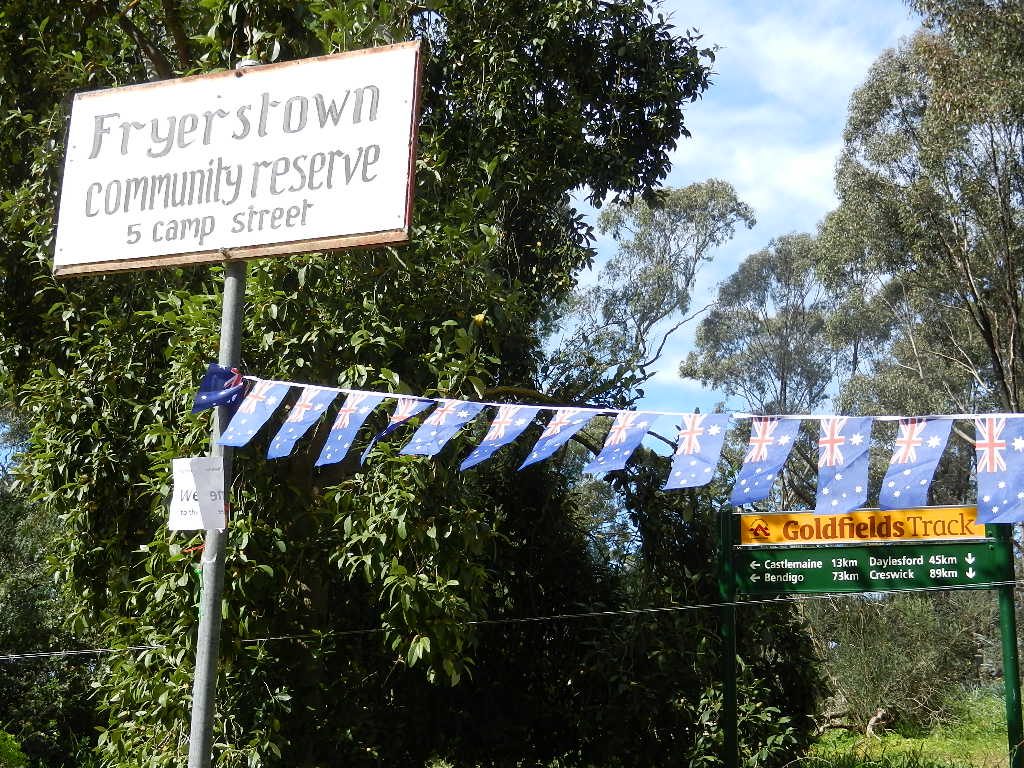 The Fryerstown Community Reserve sign at the entrance, with a Goldfields Track sign showing distances to Castlemaine, Daylesford and Bendigo